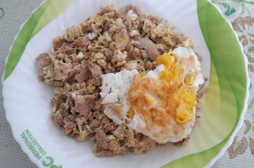 Mixed fish meat with scrambled eggs and fried egg