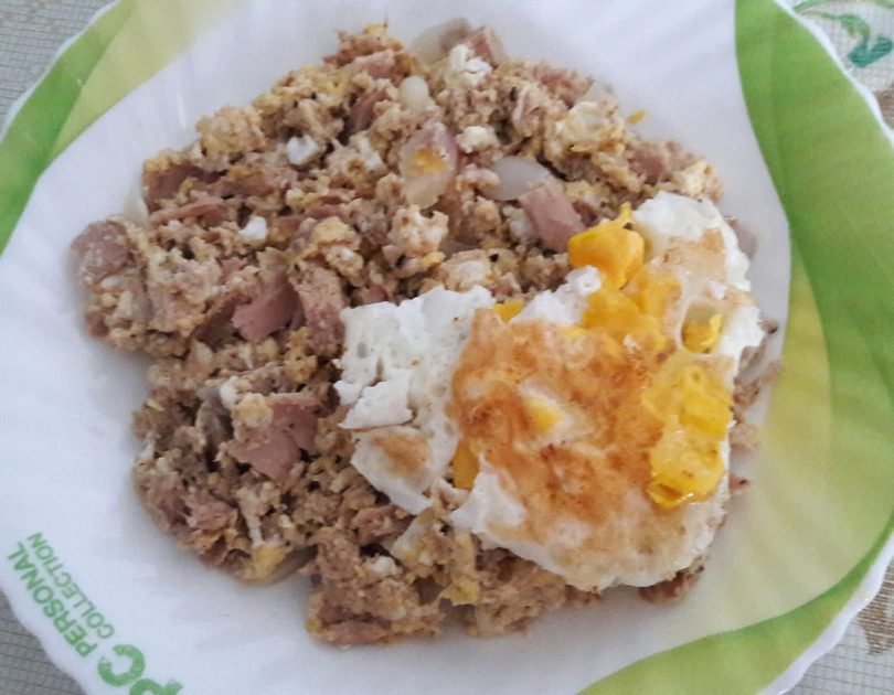 Mixed fish meat with scrambled eggs and fried egg